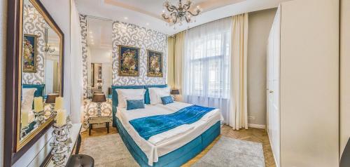 a bedroom with a bed and a chandelier at VIP Residence Riverside in Budapest
