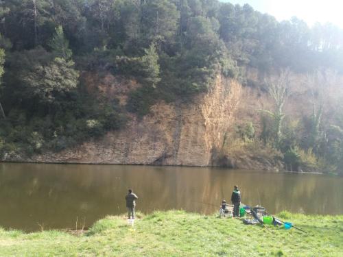 a group of three people fishing on a lake at Camping Esponellà in Esponellá