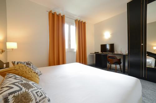 a hotel room with a bed and a desk at Novalaise Plage in Novalaise