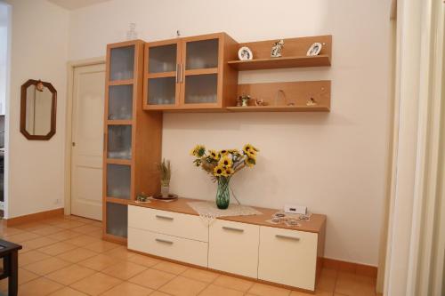 a kitchen with a vase of flowers on a counter at La Casa Dei Pargoli in Matera