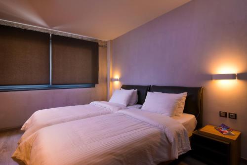a bedroom with a large bed with two white pillows at Urban Donkey in Thessaloniki