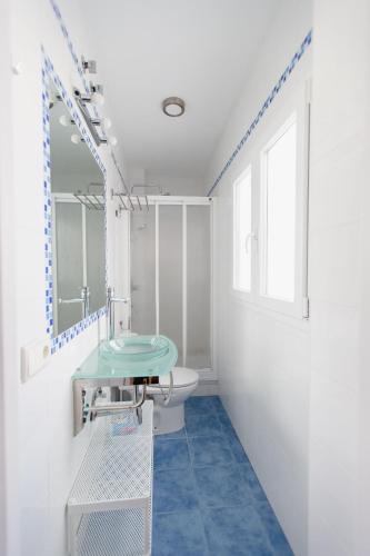 a bathroom with a sink and a toilet at Atico Centro Historico in Cádiz