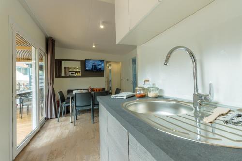 a bathroom with a large sink in a room at Diana & Josip Mobile Homes in Biograd na Moru