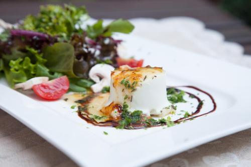 a plate of food with a salad on a table at Landhotel Becker in Kamp-Bornhofen