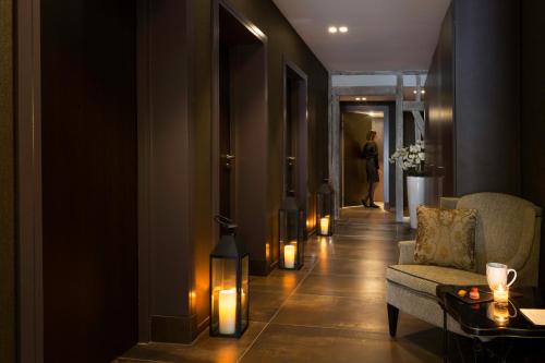 a hallway with a living room with a couch and candles at Best Western Premier de La Poste & Spa in Troyes