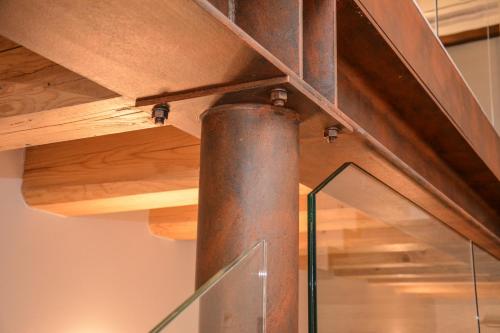 a metal pole in a room with wooden beams at Theresia in Riva del Garda