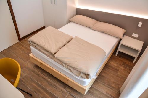 a small bed in a small room with a chair at Theresia in Riva del Garda