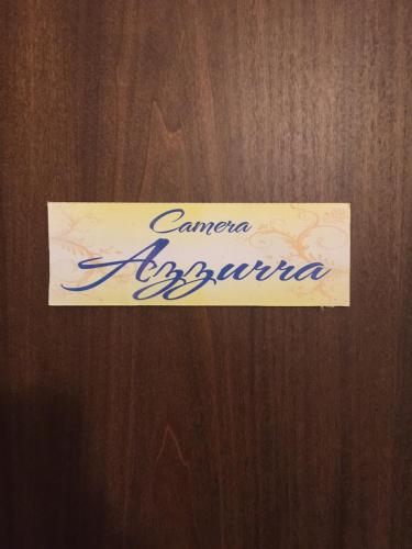 a sign on a wooden door that says cancer epidemic at Case Saniela in Terrasini