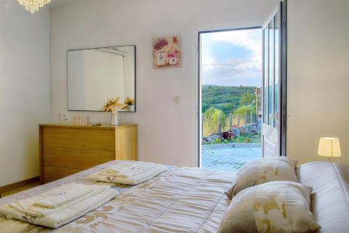a bedroom with a bed and a large window at Casa Adofreire in Melgaço