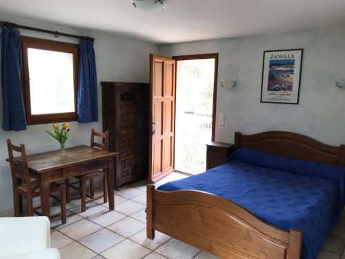 a bedroom with a bed and a table and a window at Chambre: une fenêtre sur le Ventoux in Plaisians