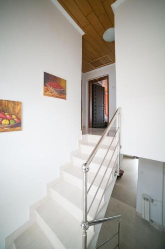 a staircase in a house with a painting on the wall at Guest House Ćiro in Sarajevo