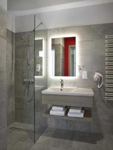 a bathroom with a sink and a shower at ibis Styles Warszawa City in Warsaw