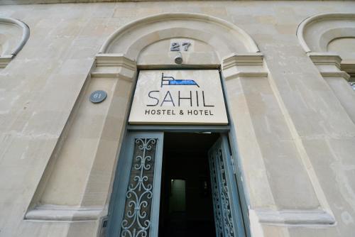 a building with a sign for a hotel at SAHIL Hostel & Hotel in Baku