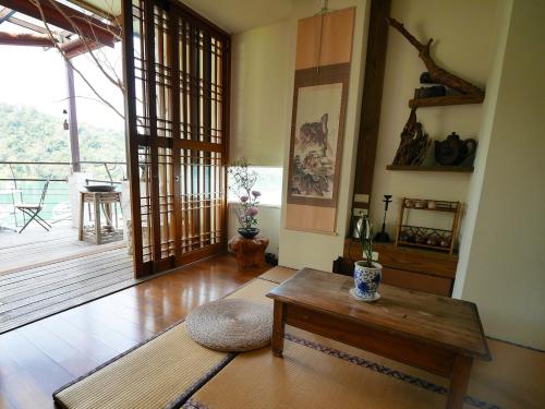 a living room with a table and a wooden floor at Cherng Yuan in Yuchi