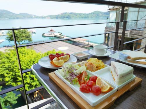 a table with a plate of food on a balcony at Cherng Yuan in Yuchi