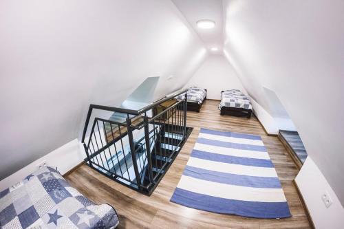 a attic room with two beds and a staircase at Villa Tower Nad Jeziorem Nyskim in Skorochow