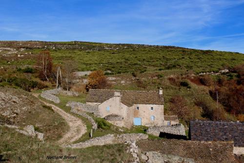 an old house on the side of a hill at Chambre d'hote de la Fage in La Fage