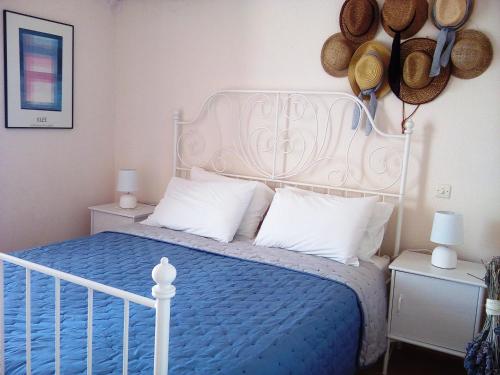 a bedroom with a white bed with a blue comforter at Adriatic View Villa in Glyfada
