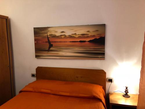 a bedroom with a bed and a painting on the wall at La Federiga in Florence