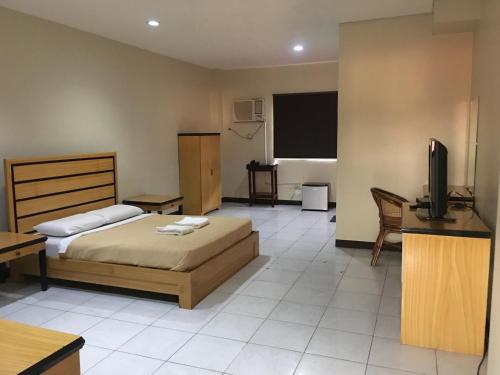 Кровать или кровати в номере South Prince Residences and Inn