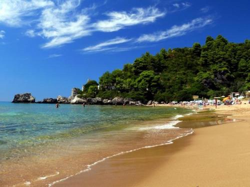 a beach with a bunch of people in the water at Adriatic View Villa in Glyfada