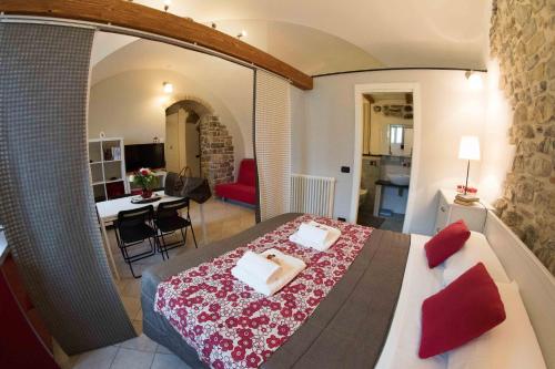 a bedroom with a large bed and a living room at Il Convento sul Mare in Santo Stefano al Mare