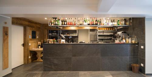 a bar with a black counter in a room at Monte Emilius in Aosta