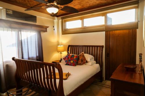 a bedroom with a bed and a ceiling fan at The Lodge at Jaguar Reef in Hopkins