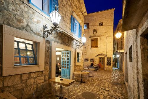 an alley in an old building with a blue door at Bubalus Boutique Rooms in Trogir