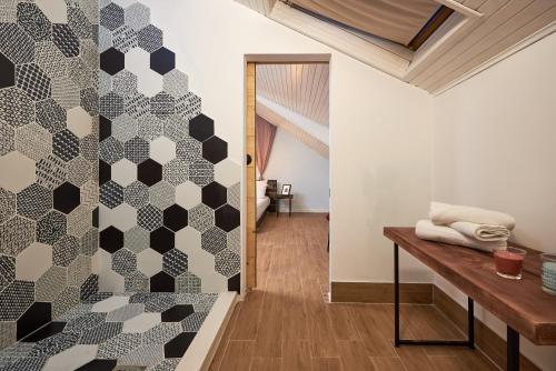 a bathroom with a geometric patterned wall at Bubalus Boutique Rooms in Trogir