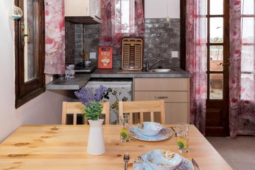 a kitchen with a wooden table with plates on it at Olympus Studios in Malia