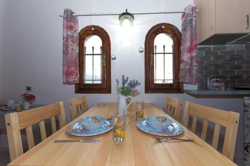 a dining room table with chairs and a wooden table with plates at Olympus Studios in Malia