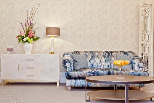 a living room with a couch and a table at Windermere Hillthwaite Hotel in Windermere