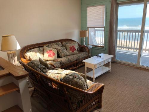 a living room with a couch, coffee table and a window at Cape Hatteras Motel in Buxton