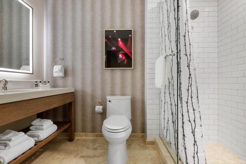 a bathroom with a toilet and a sink at Cambria Hotel Nashville Downtown in Nashville