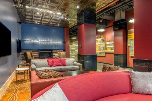 a lobby with couches and a fire place at Cambria Hotel Nashville Downtown in Nashville