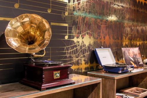 a room with a desk with a mirror and a fan at Cambria Hotel Nashville Downtown in Nashville
