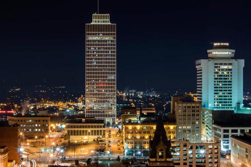 a city lit up at night with tall buildings at Cambria Hotel Nashville Downtown in Nashville