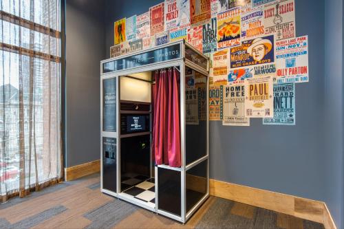 a refrigerator with a red curtain in a room at Cambria Hotel Nashville Downtown in Nashville