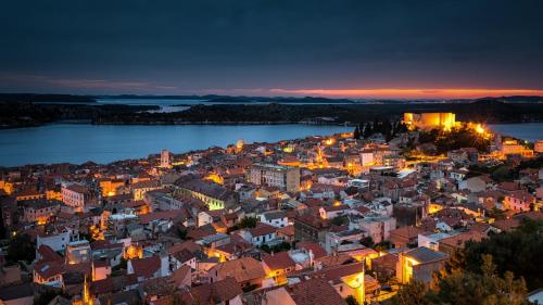 an aerial view of a city at night at Bellevue Superior City Hotel in Šibenik