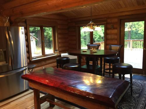 a kitchen and dining room with a table and a refrigerator at Redwood forest in Crescent City