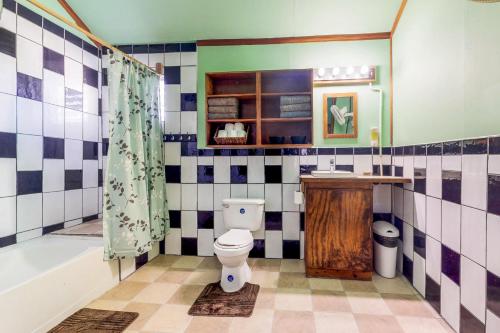 a bathroom with a toilet and a tub and a sink at Casa Jessita in Caye Caulker
