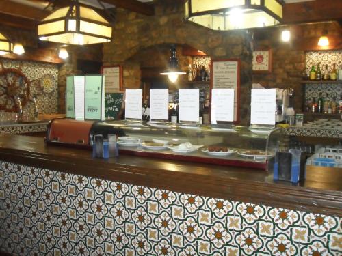 a bar with a counter with plates of food at Casa Francisco el de Siempre in El Palmar