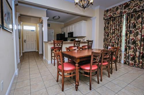 a dining room and kitchen with a wooden table and chairs at Litchfield Beach & Golf Resort in Pawleys Island