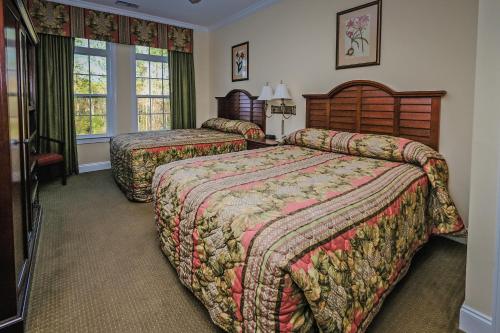 a hotel room with two beds and a television at Litchfield Beach & Golf Resort in Pawleys Island