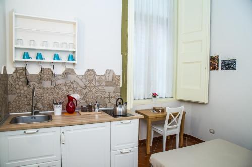 een keuken met een wastafel en een tafel bij Domus Donnaregina Apartments in Napels