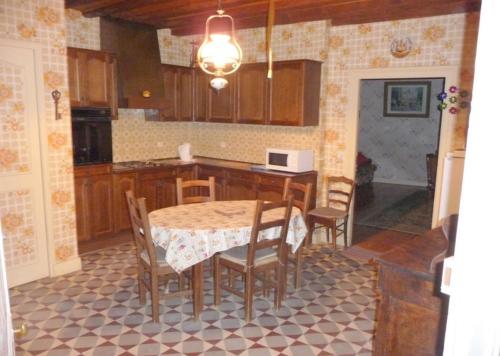 a kitchen with a table and chairs and a table and a kitchen at 2 chambres d'hôtes privées louées séparément avec communs à partager in Beaufort