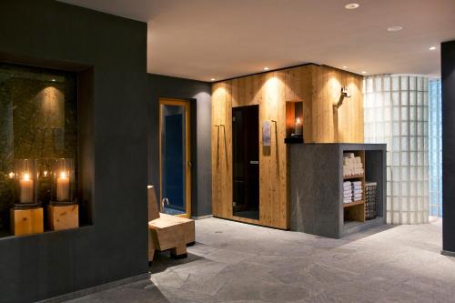 a lobby with black walls and a bench in a room at ICARO Hotel in Alpe di Siusi