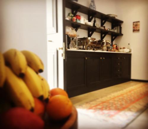 a kitchen with a bunch of bananas and tomatoes at North Point Rooms in Froúrion