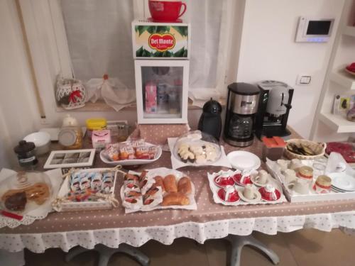 a table topped with lots of different types of pastries at I Girasoli in Bari